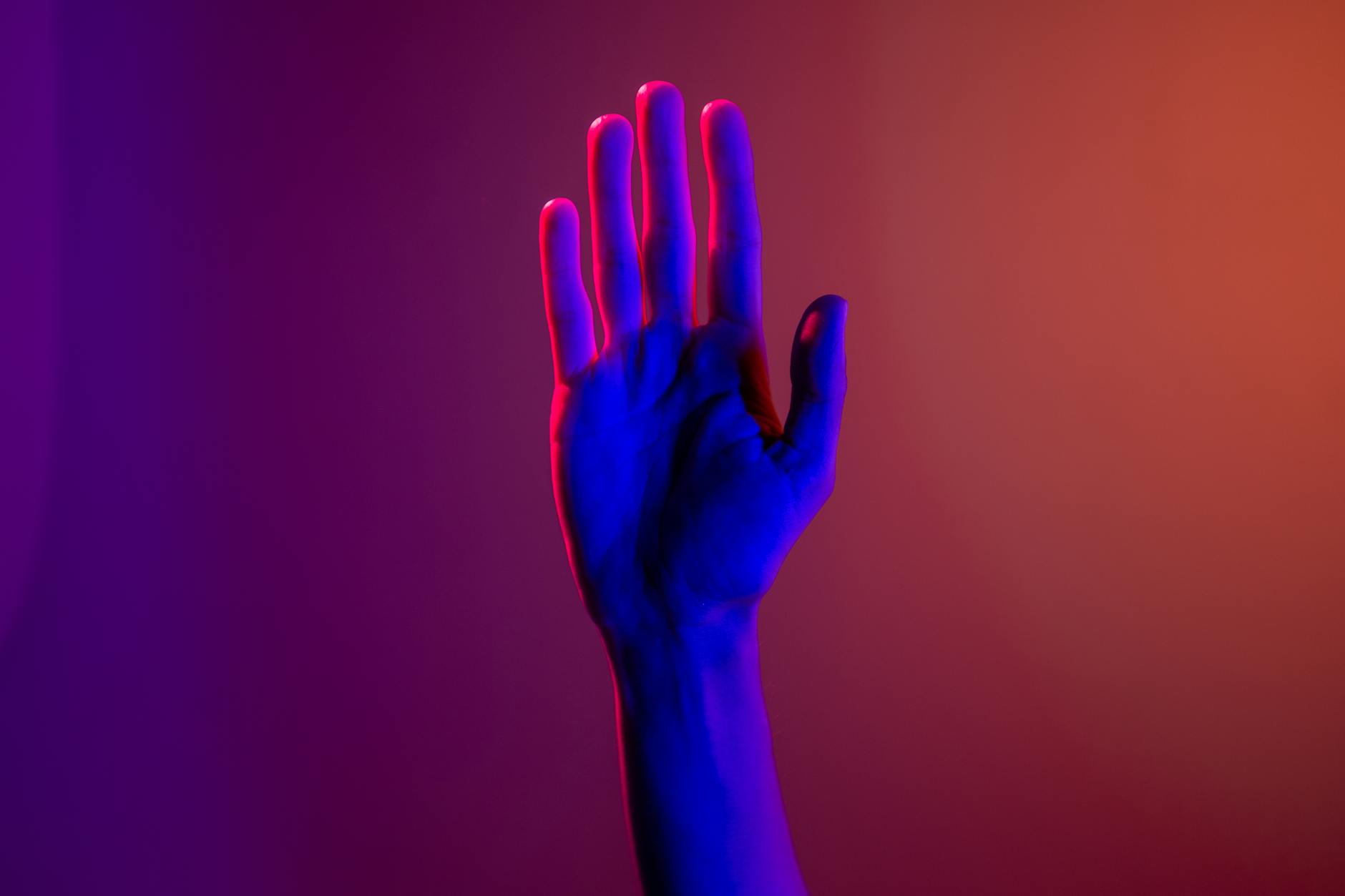 persons left hand with purple manicure